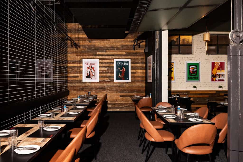 Cozy restaurant interior with modern decor and posters.