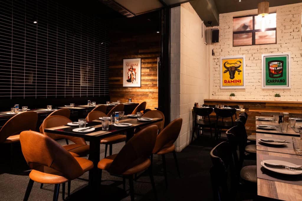 Modern restaurant interior with artwork and dining tables.